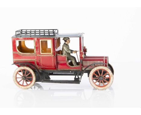 A George Carette clockwork lithographed tinplate Landaulette toy automobile circa 1910, dark red body with pale yellow, gold 