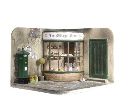 A modern miniaturist dolls’ house The Village Store corner display, with curved glass window with sweet and cake display, a d