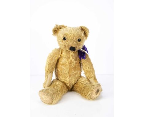 A 1930s Merrythought Teddy Bear, with golden mohair, replaced black glass eyes, pronounced clipped muzzle, black stitched nos