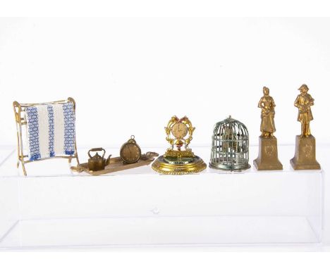German metal dolls’ house chattels,  a pair of gold painted cast lead figures on plinths —2 1/4in. (6cm.) high, mantel clock 