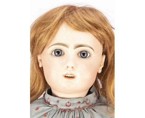 A large Tete Jumeau bebe size No 13, with fixed blue striated glass eyes, open mouth with row of top teeth, light brown feath