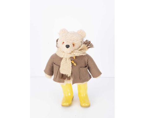 A Gabrielle Design Paddington Bear, with light brown label, yellow Dunlop wellies and label in back seam. -18 3/4in. (48cm.) 