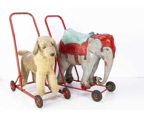 Two post-war British animals on wheels, a Chiltern mohair dog with label and red painted tubular frame with rubber wheels —20