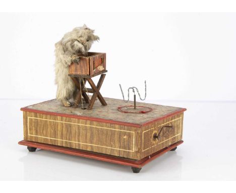 A hand-cranked musical rabbit street barrel organist automaton,  fur covered rabbit with glass eyes, wooden barrel organ, spa