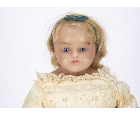 An English poured wax shoulder-head doll, probably Pierotti, fixed blue striated glass eyes, closed down turned mouth, insert