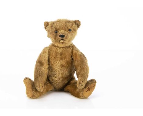 A rare small Bing Teddy Bear with all in one ears circa 1908, with dark blonde mohair, black boot button eyes, pronounced cli