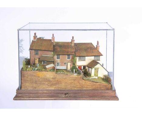 A Paul Wells of Vernacular Miniatures 1/76th scale terraced cottages model miniature houses,  set on a hill with stream, elec