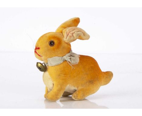A small 1930s Steiff velvet seated rabbit, of orange graduated velvet, white velvet belly and ear lining, brown and black gla