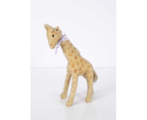 A late 1930s Steiff wool plush giraffe, with black glass eyes, pale yellow plush with airbrushed spots, felt lined ears, moha
