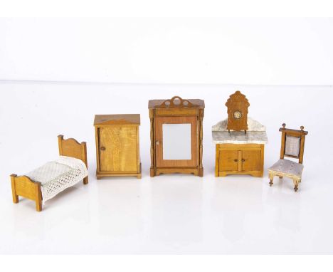 Schneegas dolls’ house furniture,  an embossed wall clock with paper dial —3 1/4in. (8cm.) high, a washstand with marble top,