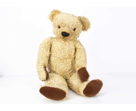 A large post-war Chad Valley Teddy Bear,  with blonde curly mohair, orange and black glass eyes, pronounced clipped muzzle, b