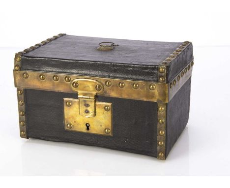 A 19th century small dolls’ trunk probably Bru, of black oil-cloth with brass banding and studs, circular handle to top, lock