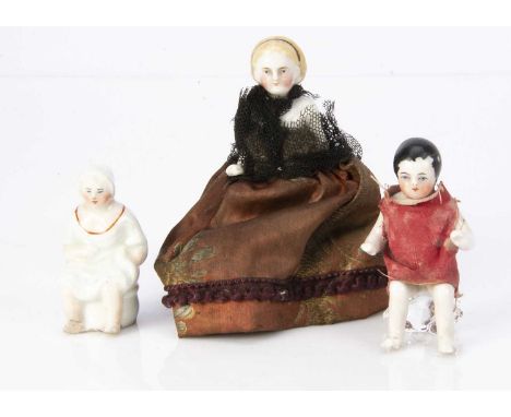 A dolls’ house china Frozen Charlotte with blonde painted and moulded hair held by a black band and homemade dress -3 1/2in. 