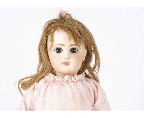 A Tete Jumeau bebe size No 7, with fixed blue striated glass eyes, closed mouth, light brown feathered brows, pierced ears, d