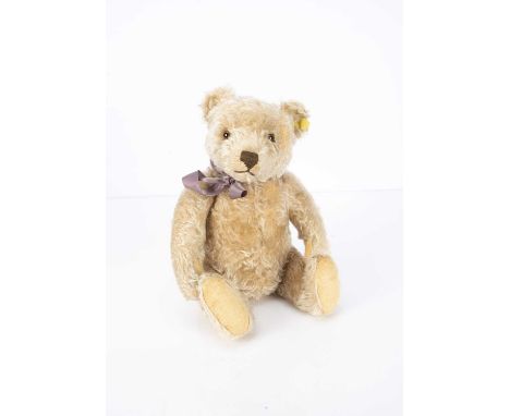 A 1950s Steiff Teddy Bear, with beige mohair, clear and black glass eyes with brown backs, pronounced muzzle, brown stitched 