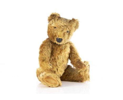 A post war Chiltern Teddy Bear, with golden brown mohair, clear and black glass eyes with remains of painted backs (one eye m