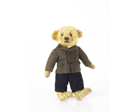 An interesting 1920s J K Farnell Teddy Bear in well made suit, with golden mohair, clear and black  glass eyes with a grey ba