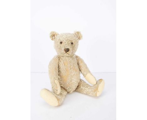 A 1950s Steiff Teddy Bear, with beige mohair, clear and black glass eyes with brown backs, pronounced muzzle, brown stitched 