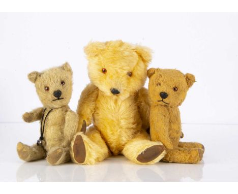 Three post-war Chiltern Teddy Bears,  including a golden mohair, orange and black plastic eyes, black plastic nose, black sti