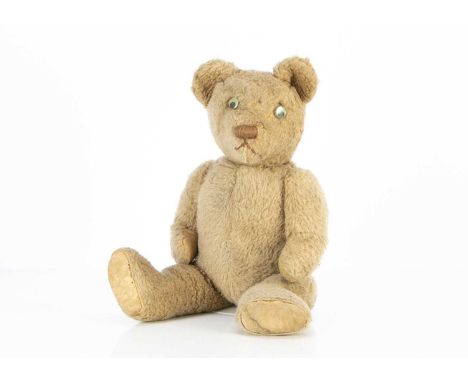 A 1940-50s Invicta Teddy Bear, with light brown wool plush, replaced plastic googly eyes, browns stitched nose and mouth, swi