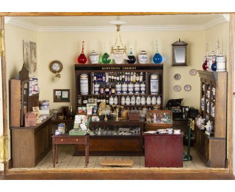 A very detailed dolls’ house model miniature 1/12th scale Chemist Shop by Bob Willans,  the vanished plywood building with tw