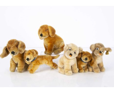 Post-war Steiff dogs,  three seated Bazi —6in. (15cm.) high, a running Bazi and two seated Mopsy, one with script button and 