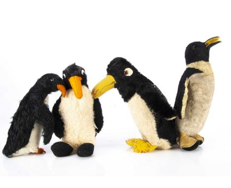 Four British soft toy penguins,  a Chad Valley 1930s penguin with black mohair, orange and black glass eyes, yellow felt beak