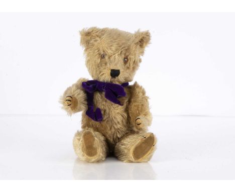 A small post-war Chiltern Teddy Bear, with light brown mohair, orange and black glass eyes, black stitched nose, mouth and cl