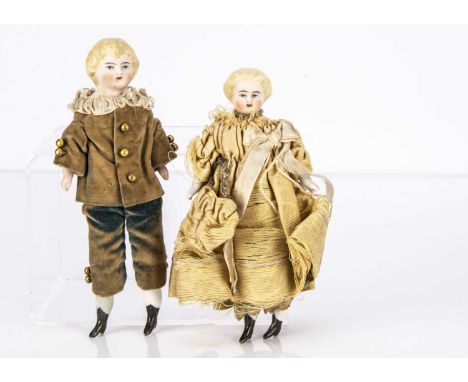 Two larger scale dolls’ house bisque shoulder head dolls, with blonde painted and moulded hair, blue painted eyes, bisque lim