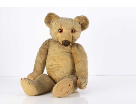 A 1930's Chad Valley Teddy Bear, with blonde mohair, replacement orange and black glass eyes, black stitched bulbous nose, mo