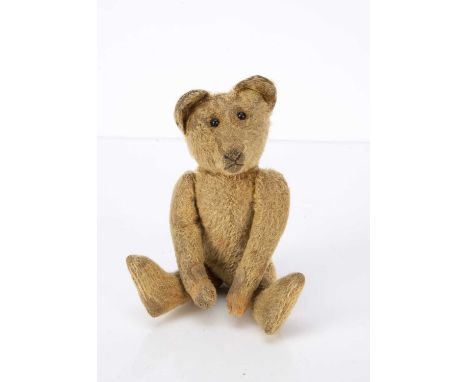 An early Teddy Bear 1910-20s, probably American with golden mohair, black boot button eyes, pronounced muzzle, brown stitched