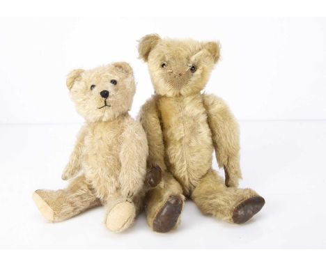 Two 1920-30s Teddy Bears,  a British teddy bear with blonde mohair, clear and black glass eyes with brown painted eyes, prono