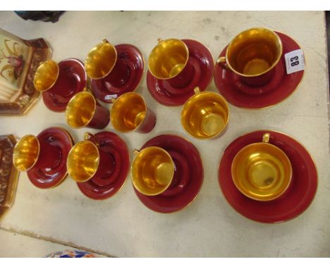  A Crown Devon red/gilt part coffee set, one cup chipped, 11 cups, 12 saucers