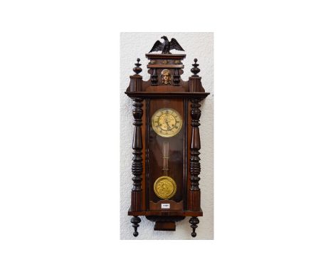Vienna Wall Clock typical form, spring driven movement with pendulum. Mahogany veneered case, eagle finial. Height 38 inches