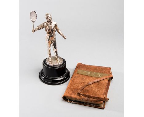 An Impressively detailed 1930s silvered tennis figurine of a gentleman about to play a forehand shot,he holds an unusual rack