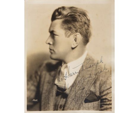 A Gene Tunney signed photograph,a fine 10 by 8in. 1937 studio portrait photograph by Apeda of New York, signed in fountain pe