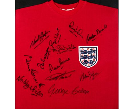 A signed framed red England 1966 World Cup Final retro jersey,signed after the passing of Bobby Moore by the other 10 England