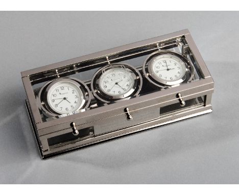 An Aquascutum silver-plated three face ship's clock bearing a glass etched Arsenal FC crest and being a commemoration of the 