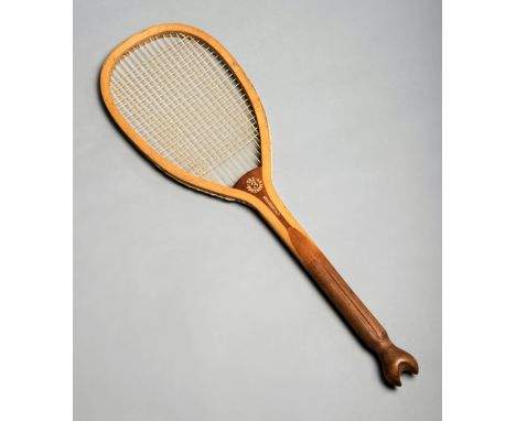 A 'Tournament 3' lawn tennis racquet by Bussey & Co circa 1896,with a striking fishtail, deeply grooved handle, and in seemin