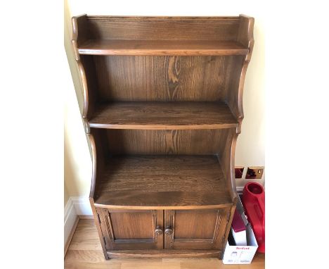 Ercol bookcase cabinet with doors below. 