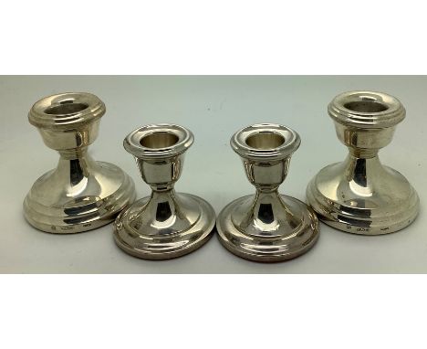 Two pairs of silver candlesticks, tallest 6.5cms h. 