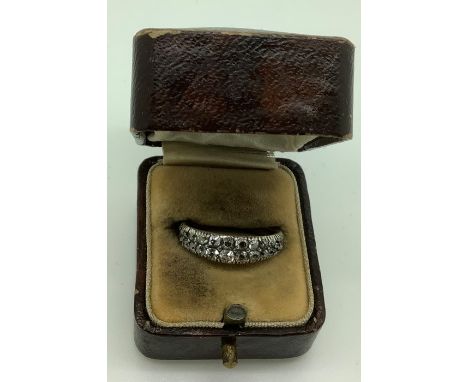 An unmarked ring with two bands of clear stones set in an unmarked yellow metal, band size M/N, weight 2.9gms total, in a vin