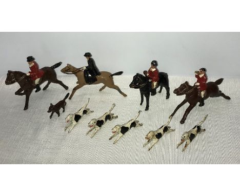 Vintage cast metal models of Huntsmen women, fox and hounds with a DInky wheelbarrow and Indians with campfire. 