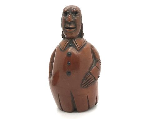 A late 18th/early 19thC coquilla nut novelty snuff box in the form of a gentleman with long buttoned coat, hinge and feet mis