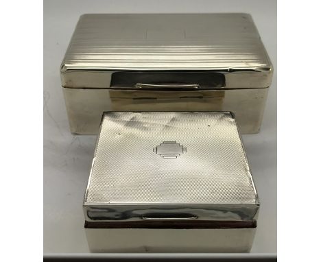 Two silver cased cigarette boxes, Chester 1940 and Birmingham 1929. Some dents.