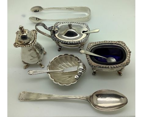Silver to include a 3 piece cruet with blue glass and spoons, a glass lined shell shaped container with knife, teaspoon and s