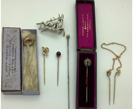 Two boxed stick pins in the form of horseshoes, one 9ct gold with seed pearls, make MB &amp; Co. an unmarked double flower wi