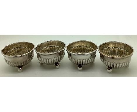 Four silver salts, reeded with ball feet, Birmingham 1875. 88.2gms. 