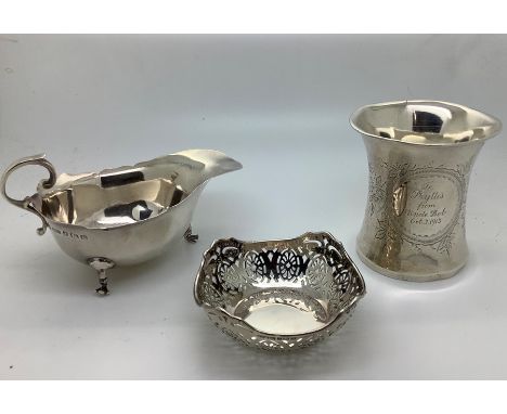 Silver to include sauce boat Birmingham 1938, a christening mug Birmingham 1911 with inscription, slightly dented to base and