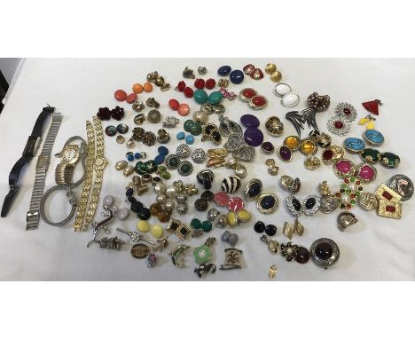 A large quantity of vintage clip on earrings, brooches, ladies wristwatches including one marked Must De Cartier (broken face